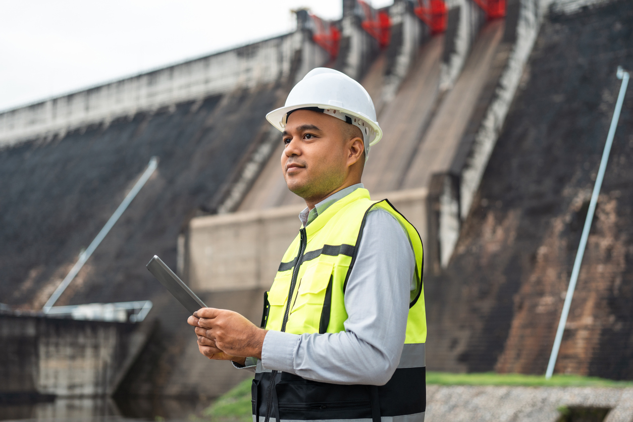 Professional asian maintenance engineer man with safety helmet in construction site dam with hydroelectric power plant and irrigation. Manager engineer man working at project big building. Professional asian maintenance engineer man with safety helmet in construction site dam with hydroelectric power plant and irrigation. Manager engineer man working at project big building.